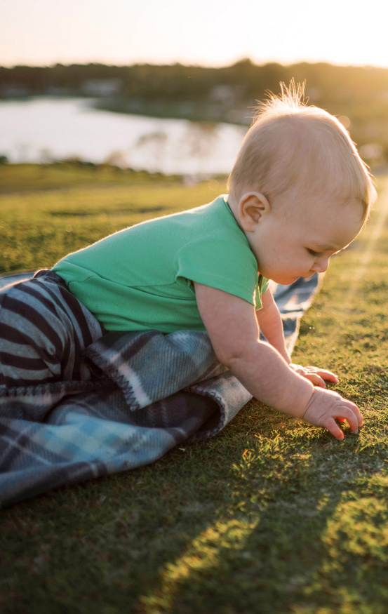 baby playing in grass small