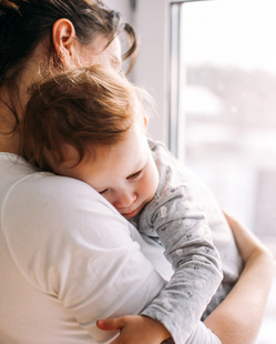 baby sleeping on mothers shoulder