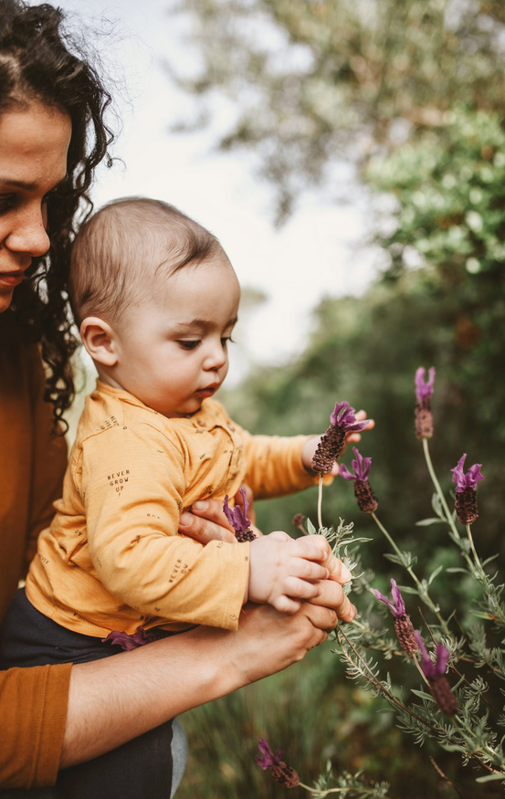 baby plucking flowers with mom