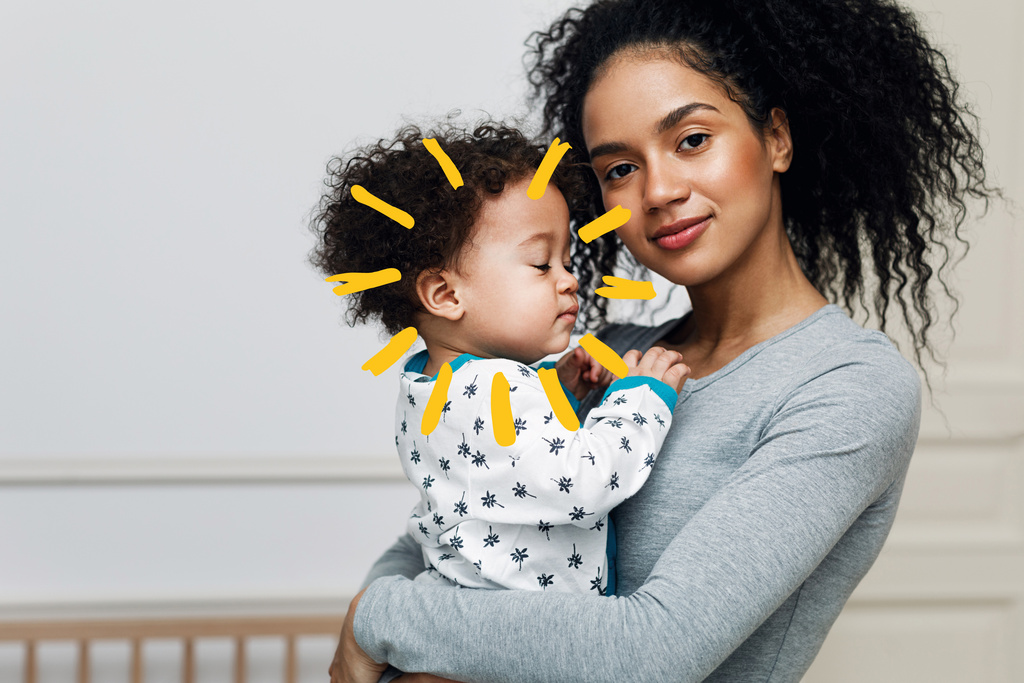 Mom carrying baby on arm sunshine 